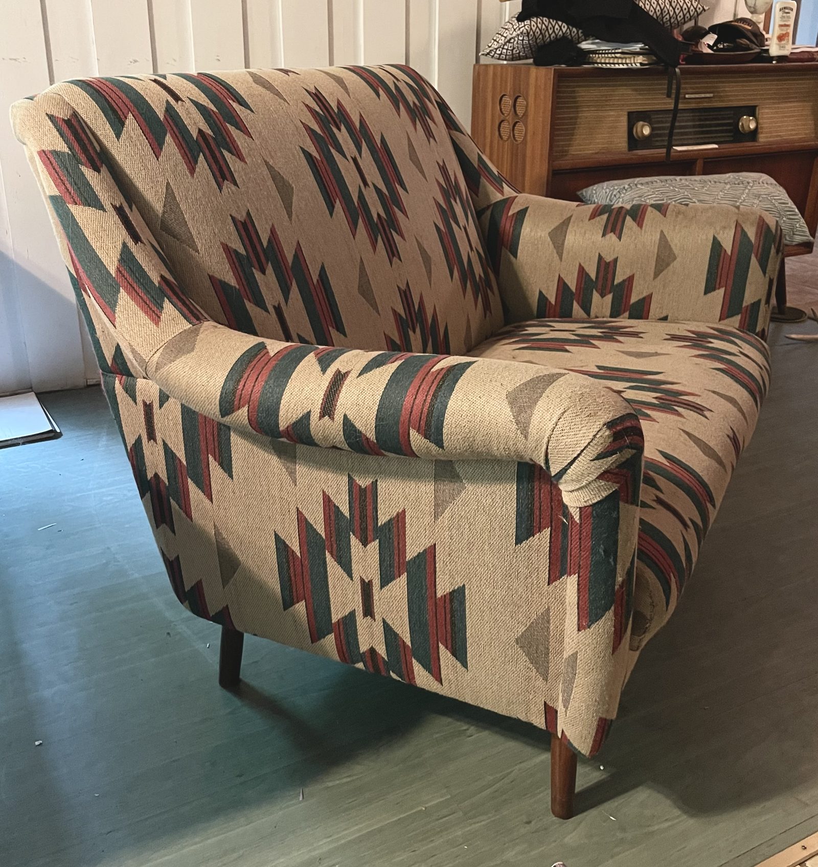 Loveseat before reupholstery, dated pattern and worn fabric